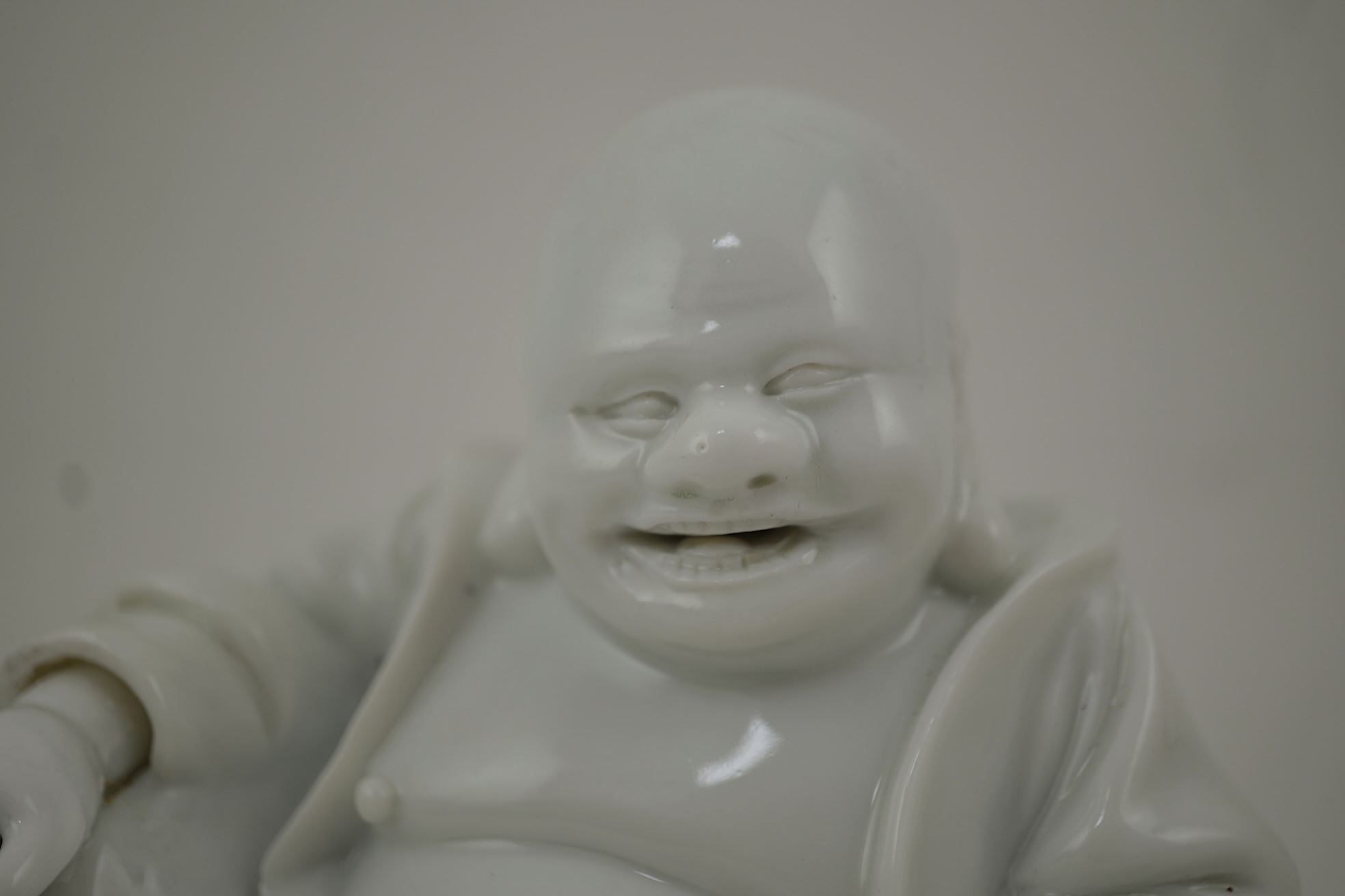 A Chinese blanc-de-chine seated figure of Budai, 18th/19th century